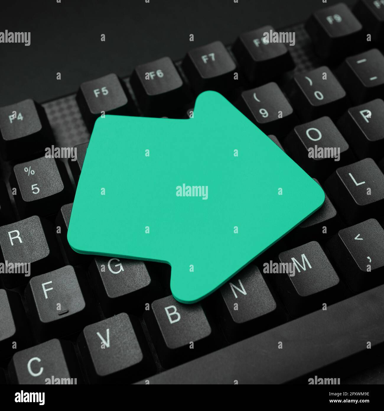 Color paper with important message laying on black Computer keyboard. Stock Photo