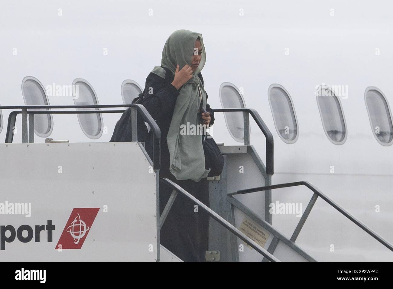 People evacuated from sudan arrive on a flight from cyprus into
