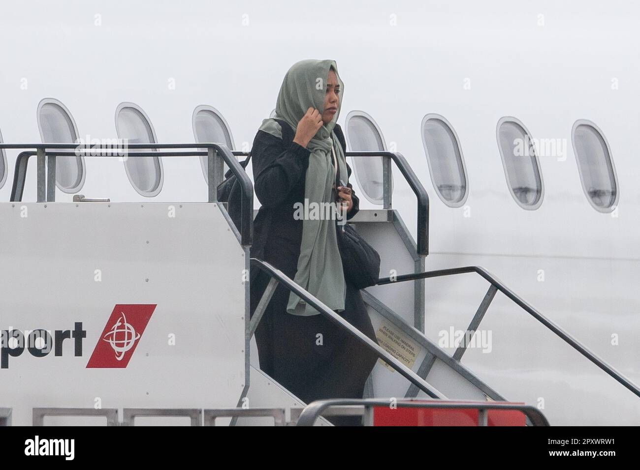 People evacuated from sudan arrive on a flight from cyprus into