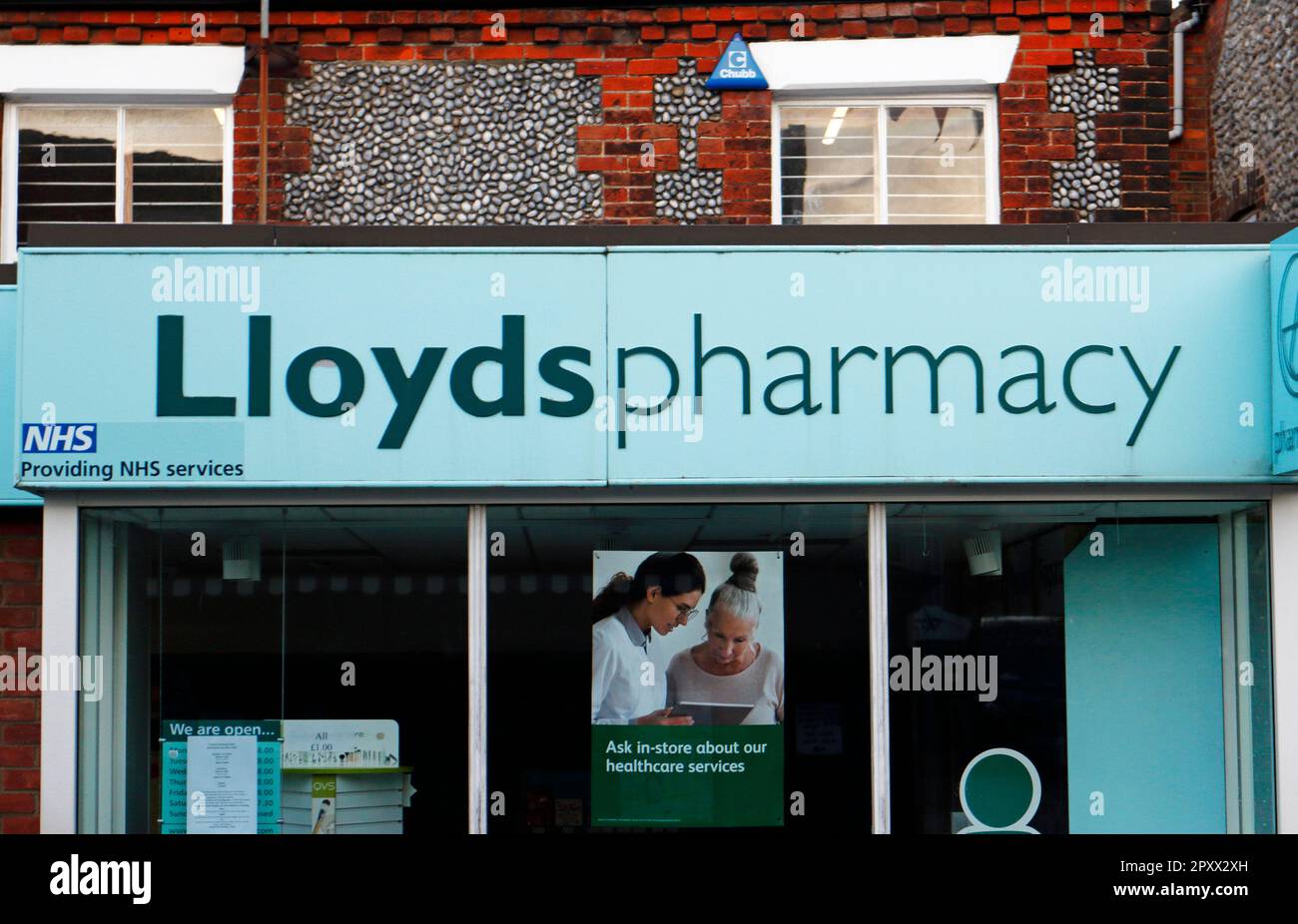 A view of the fascia above the shop front advertising LLoyds Pharmacy in the North Norfolk town of Sheringham, Norfolk, England, United Kingdom. Stock Photo