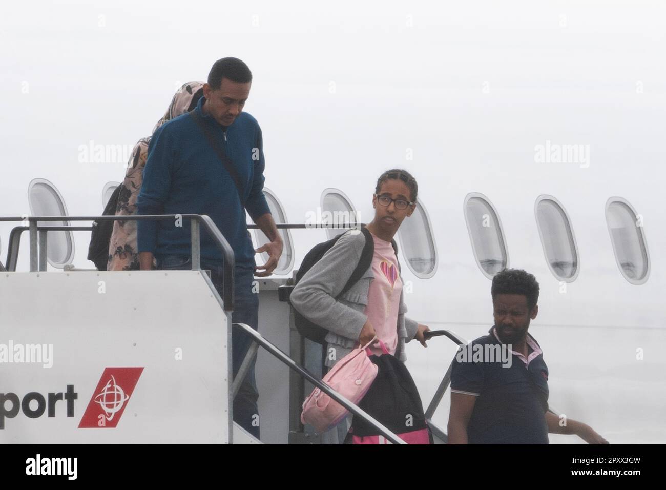 People evacuated from sudan arrive on a flight from cyprus into