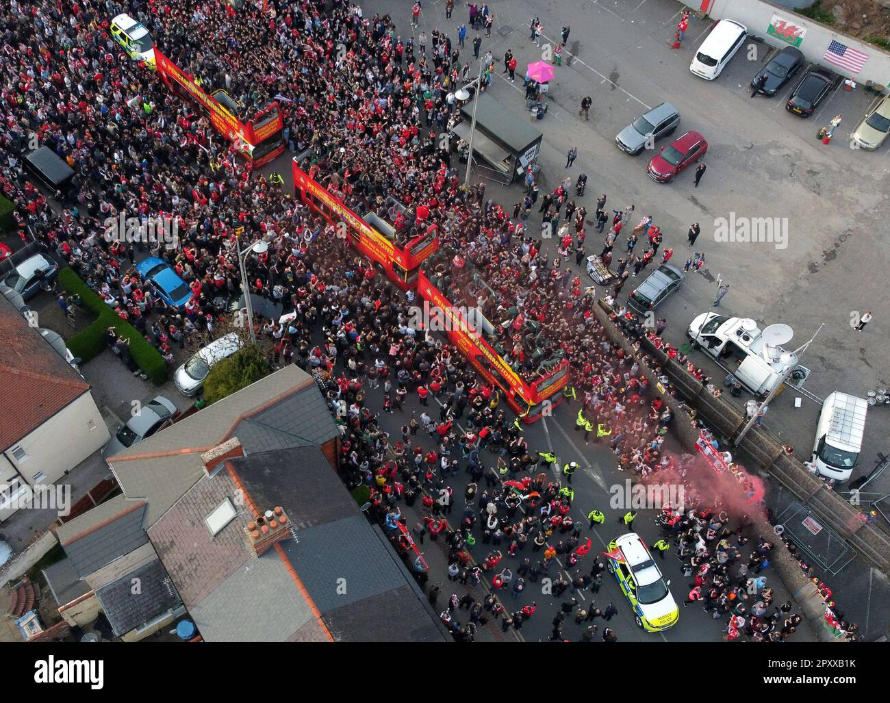 An aerial view of opentop busses carrying Wrexham players past the