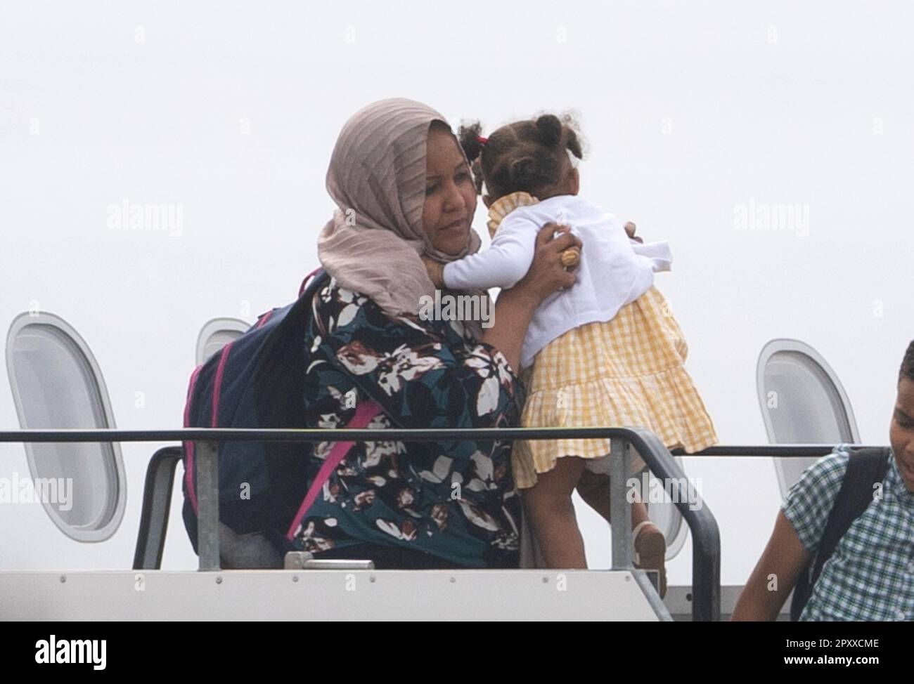 People evacuated from sudan arrive on a flight from cyprus into