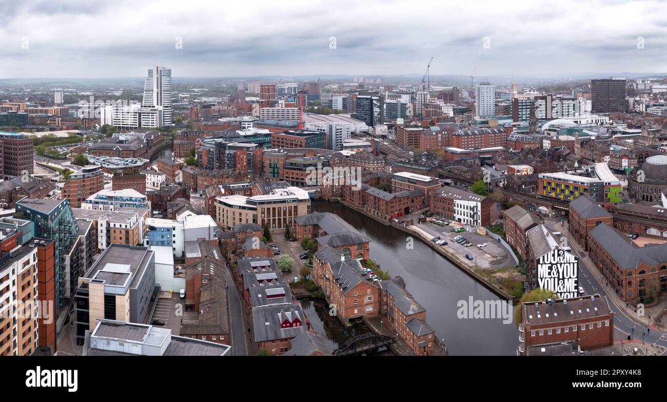 An aerial panoramic view of a Leeds cityscape skyline with the River Aire running through Brewery Wharf's waterfront apartment buildings Stock Photo