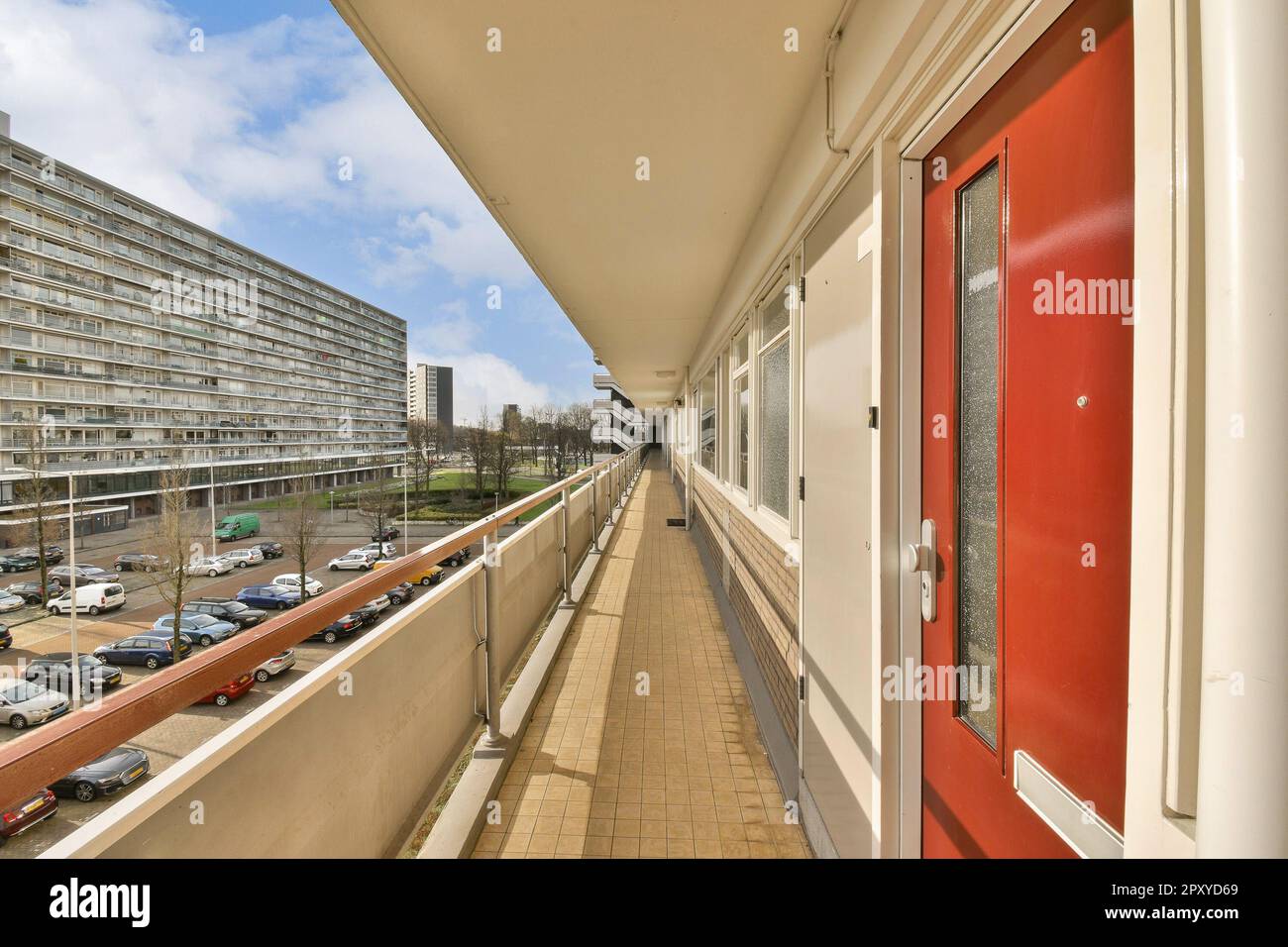 a balcony with cars parked on the sidewalk and buildings in the ...