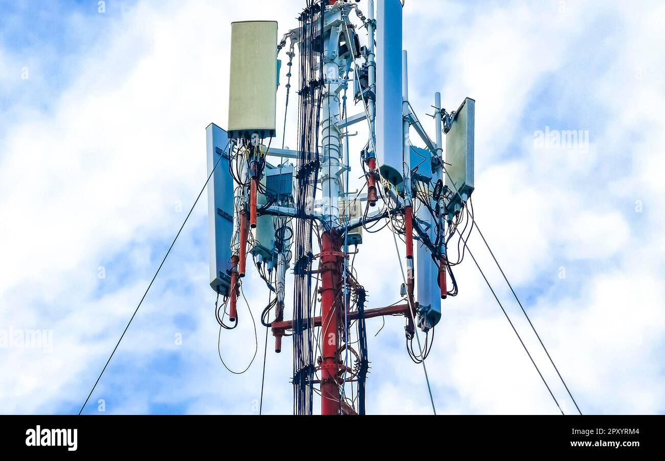 Red white 5G tower with blue sky background radiation kills us in Playa del Carmen in Mexico. Stock Photo