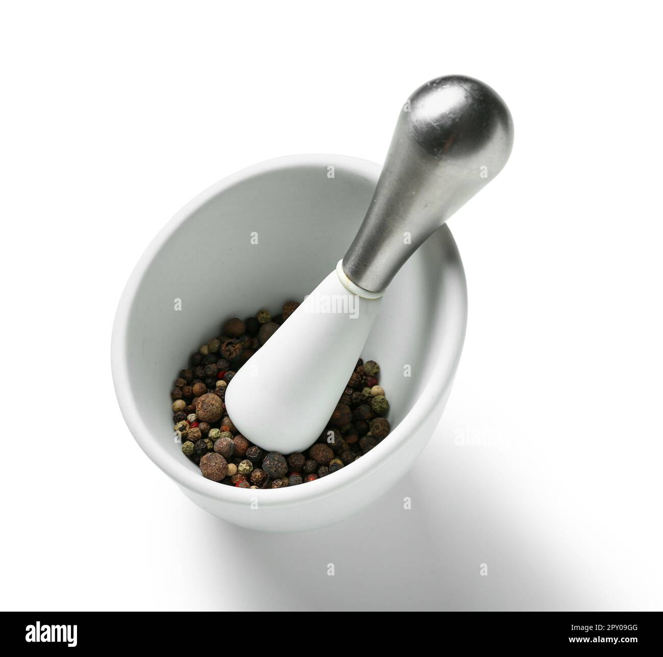 Mortar and pestle with peppercorns isolated on white background Stock