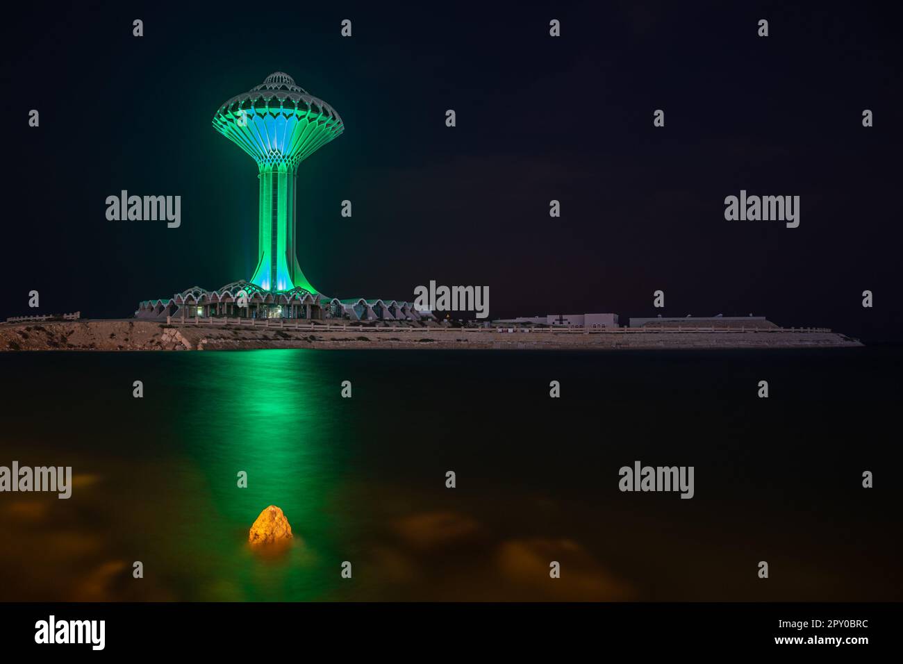 Al Khobar water tower illuminated in green during the night on the sea shore, Dammam, Saudi Arabia Stock Photo