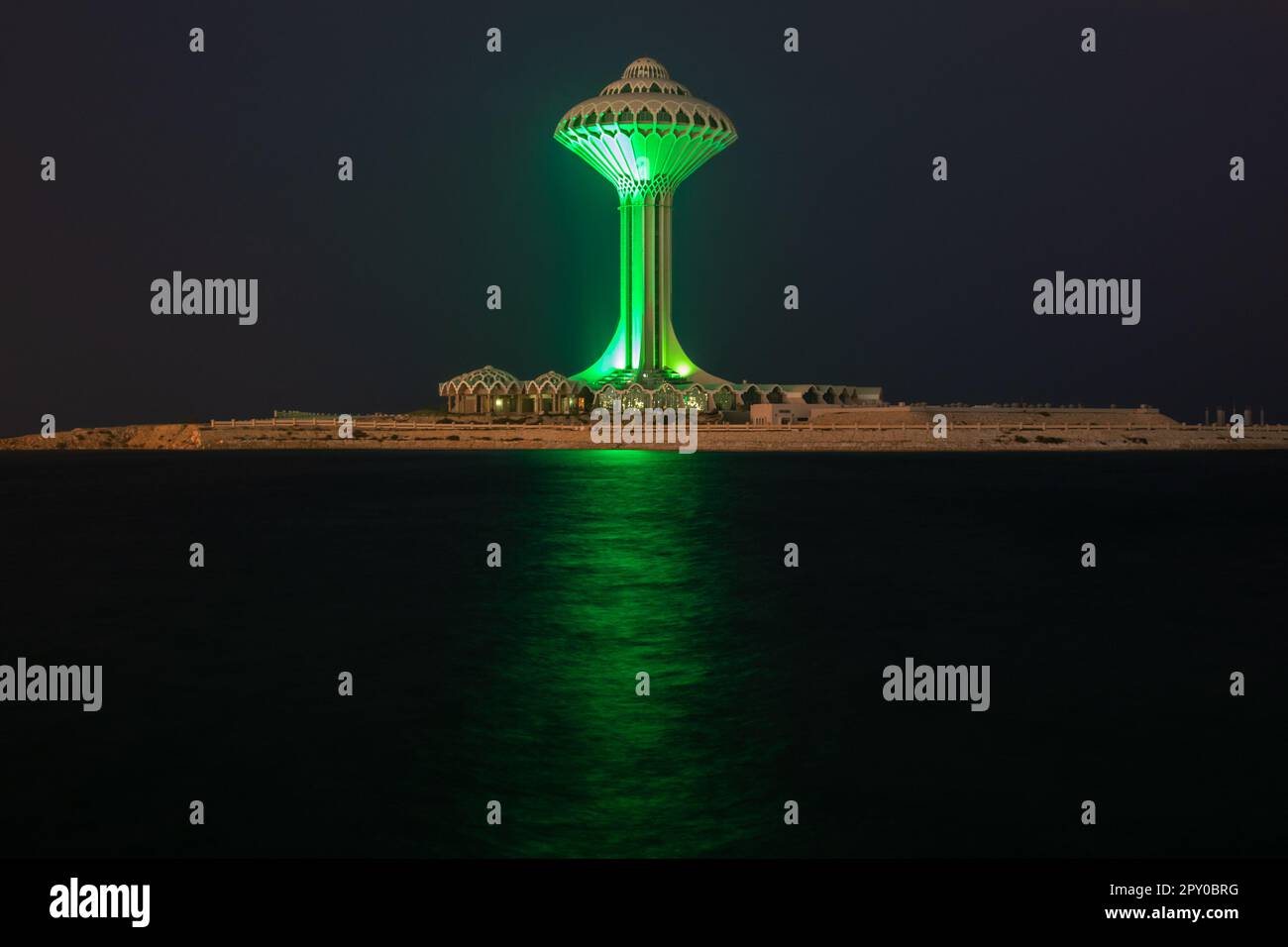Al Khobar water tower illuminated in green during the night on the sea shore, Dammam, Saudi Arabia Stock Photo