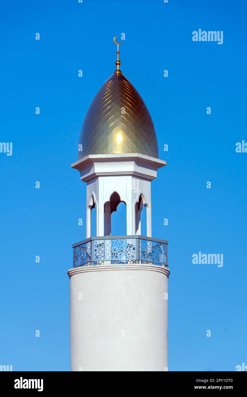 A Muslim golden dome with a crescent moon on the mosque. Minaret