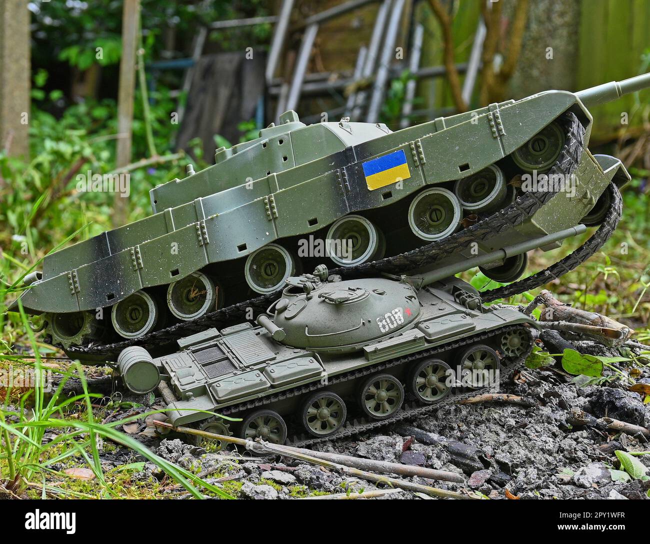 Modern western tank crushing a Russian T62 model tank Stock Photo