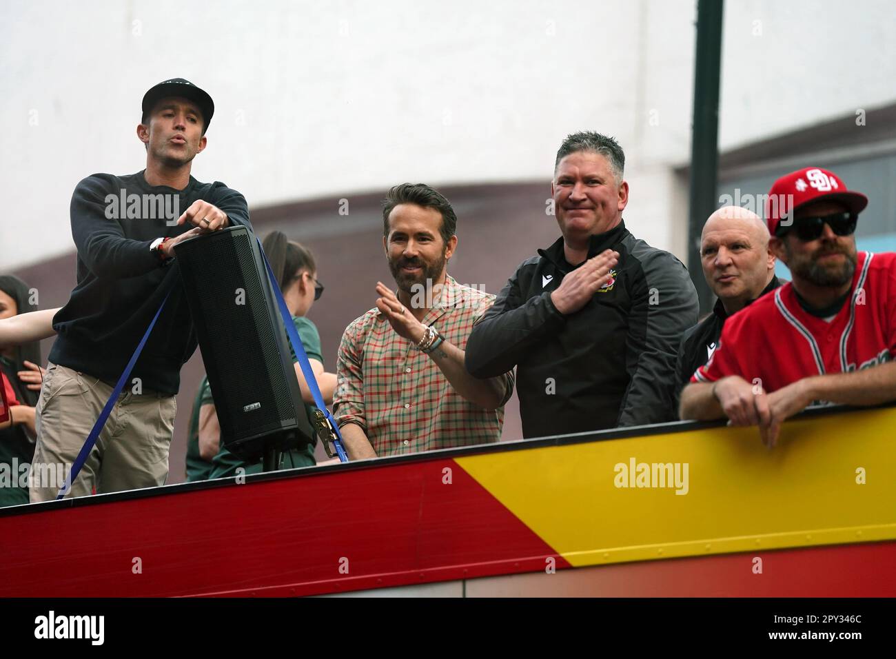 Wrexham coowners Rob McElhenney and Ryan Reynolds celebrate on an open