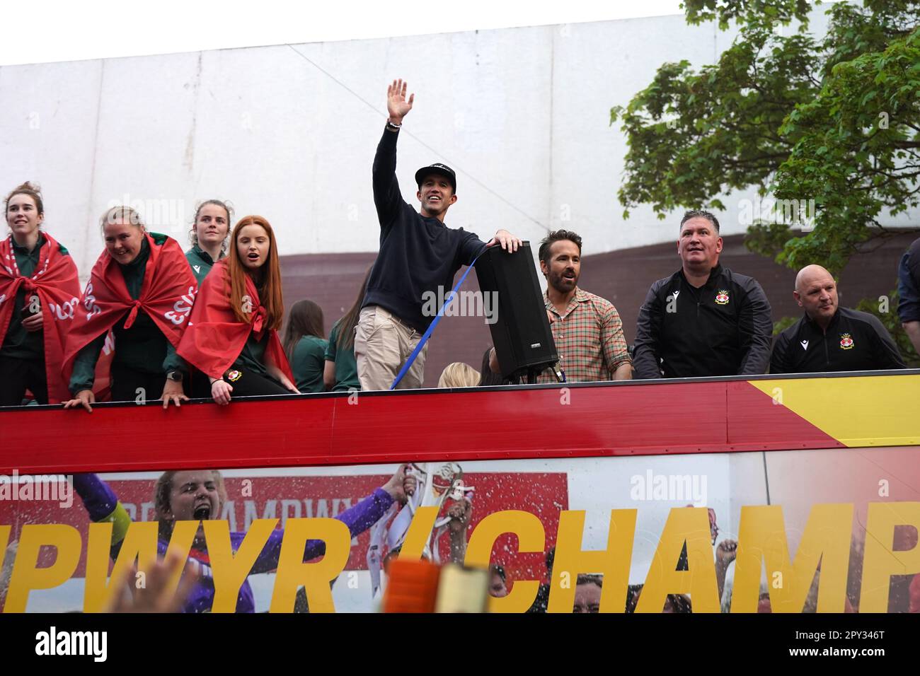 Wrexham coowners Rob McElhenney and Ryan Reynolds celebrate on an open