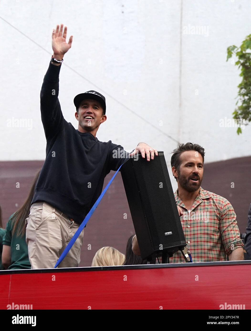 Wrexham coowners Rob McElhenney and Ryan Reynolds celebrate on an open