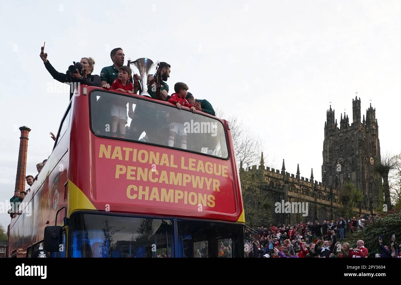 Wrexham players celebrate on an opentop