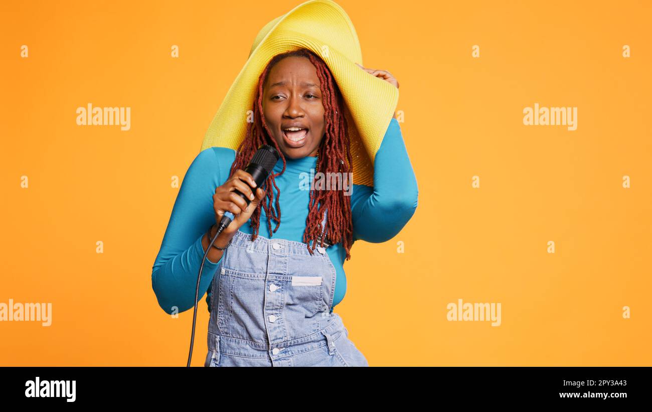 Joyful person singing song at microphone, doing karaoke session in