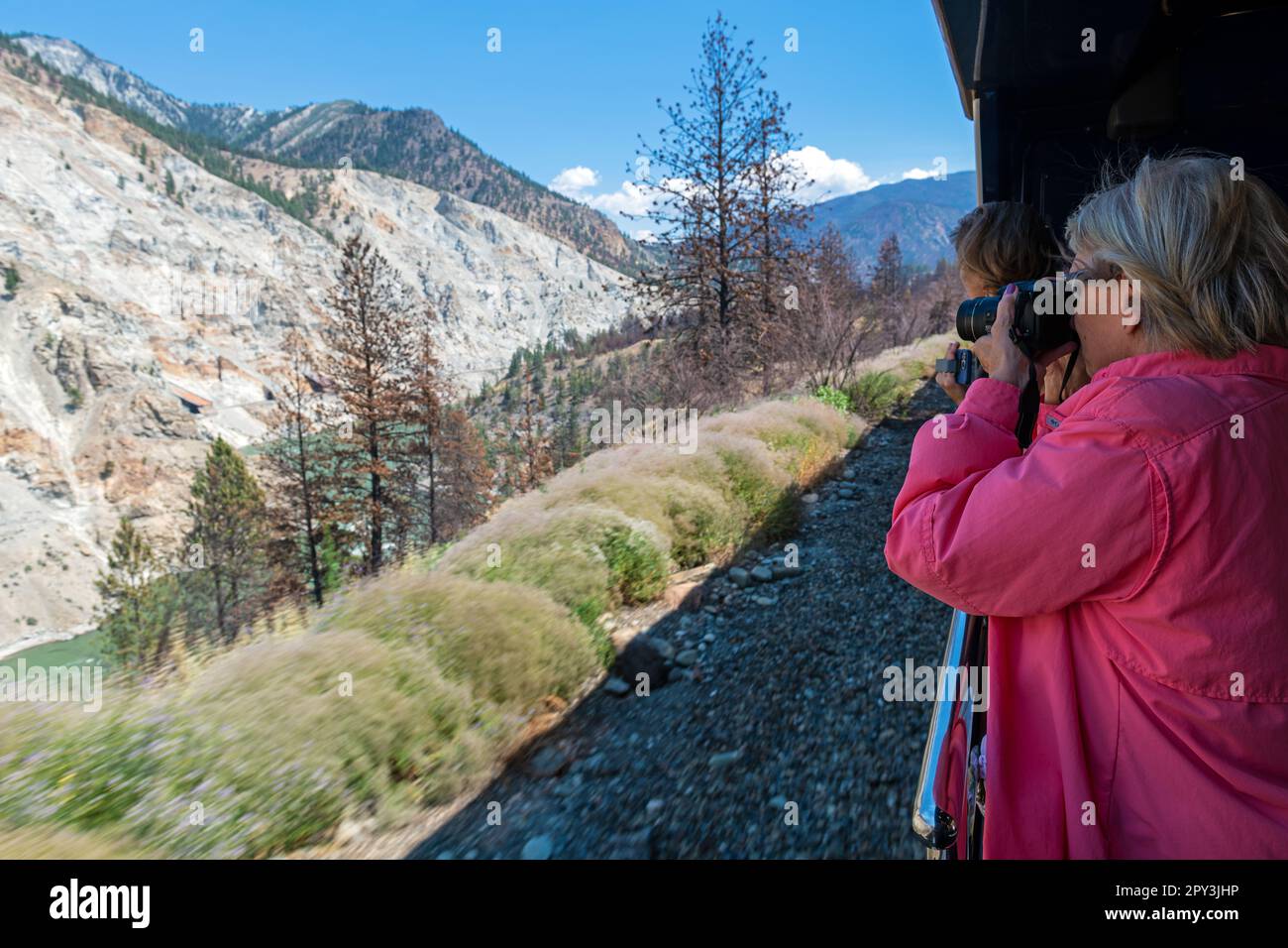 Tourist taking photographs of Fraser River and Valley, Rocky Mountaineer train, Canada. Stock Photo