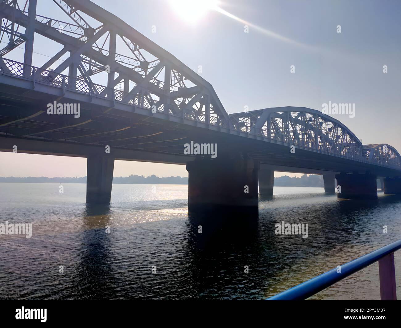 A picturesque view of a bridge in Kolkata on a sunny day, with a blue sky in the background Stock Photo