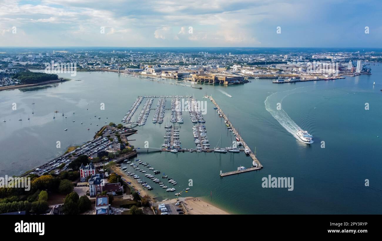 German WWII submarine base of Lorient in Brittany, France - Modern Kernevel marina facing the nazi U-boat factory and bunker of Keroman (K3) on the co Stock Photo