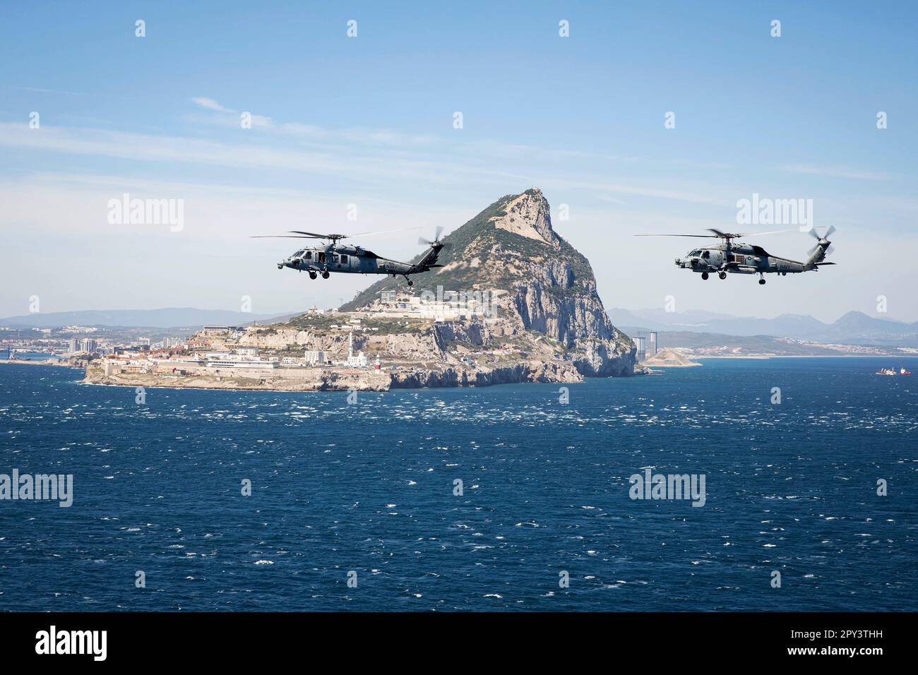 Strait Of Gibraltar. 12th Apr, 2023. An MH-60S Nighthawk helicopter, attached to Helicopter Sea Combat Squadron (HSC) 5, and an MH-60R Sea Hawk helicopter, attached to Helicopter Maritime Strike Squadron (HSM) 46, fly in formation while transiting the Strait of Gibraltar, April 12, 2023. Carrier Air Wing (CVW) 7 is the offensive air and strike component of Carrier Strike Group (CSG) 10 and the George H.W. Bush CSG. The squadrons of CVW-7 are Strike Fighter Squadron (VFA) 143, VFA-103, VFA-86, VFA-136, Carrier Airborne Early Warning Squadron (VAW) 121, Electronic Attack Squadron (VAQ) 140, HS Stock Photo