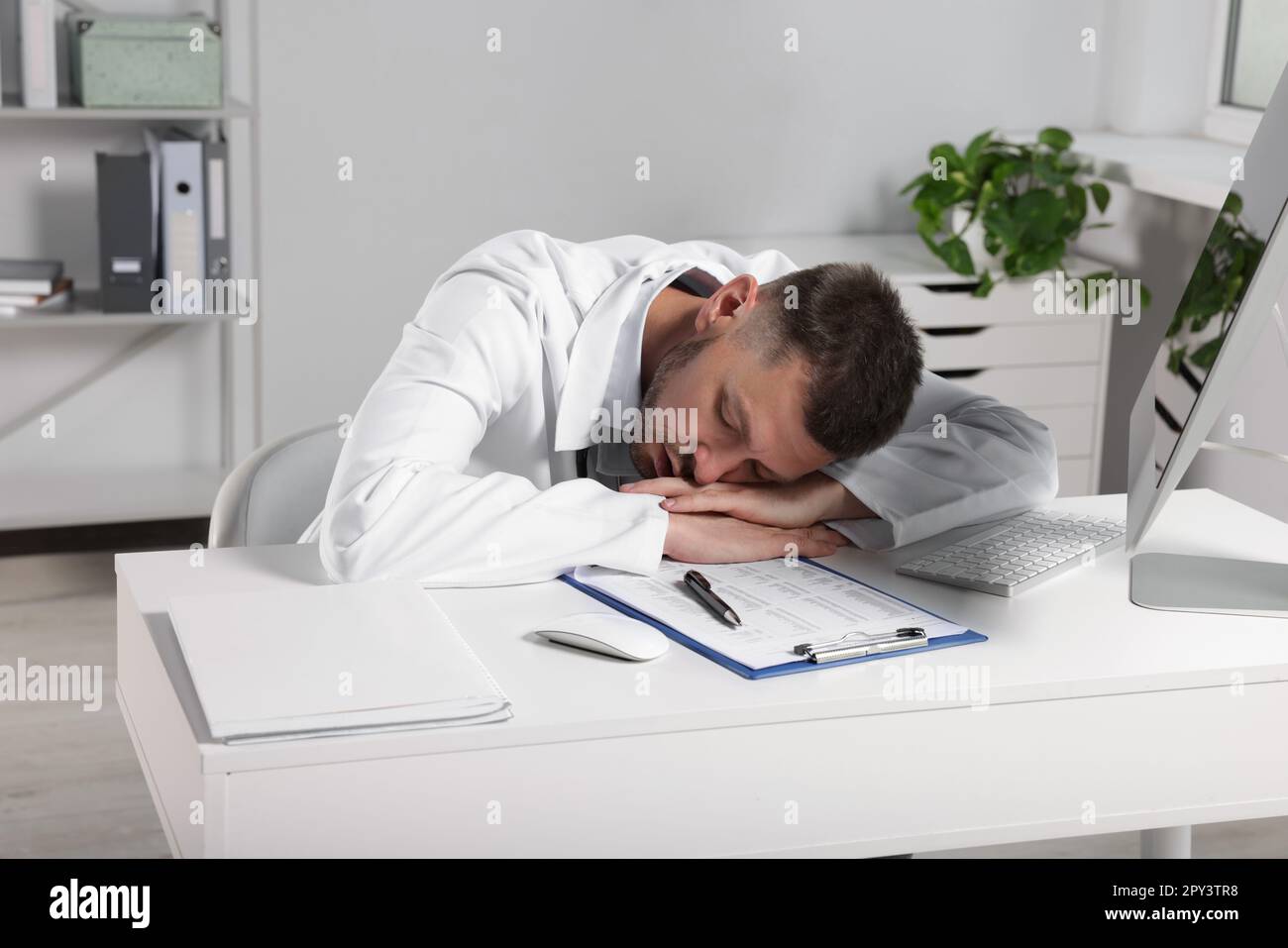 Doctor sleeping at desk hi-res stock photography and images - Alamy