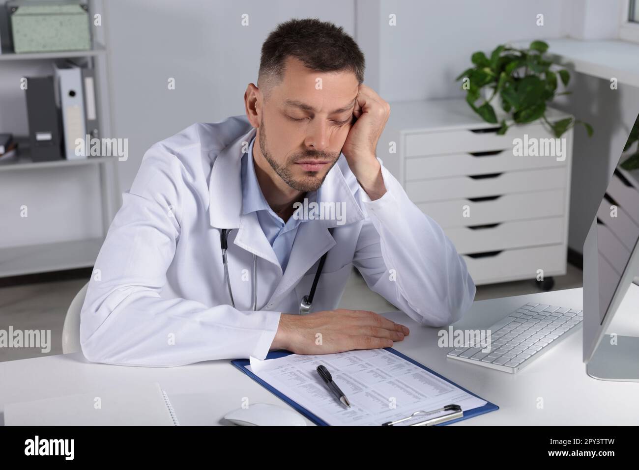 Exhausted doctor sleeping workplace hi-res stock photography and images ...