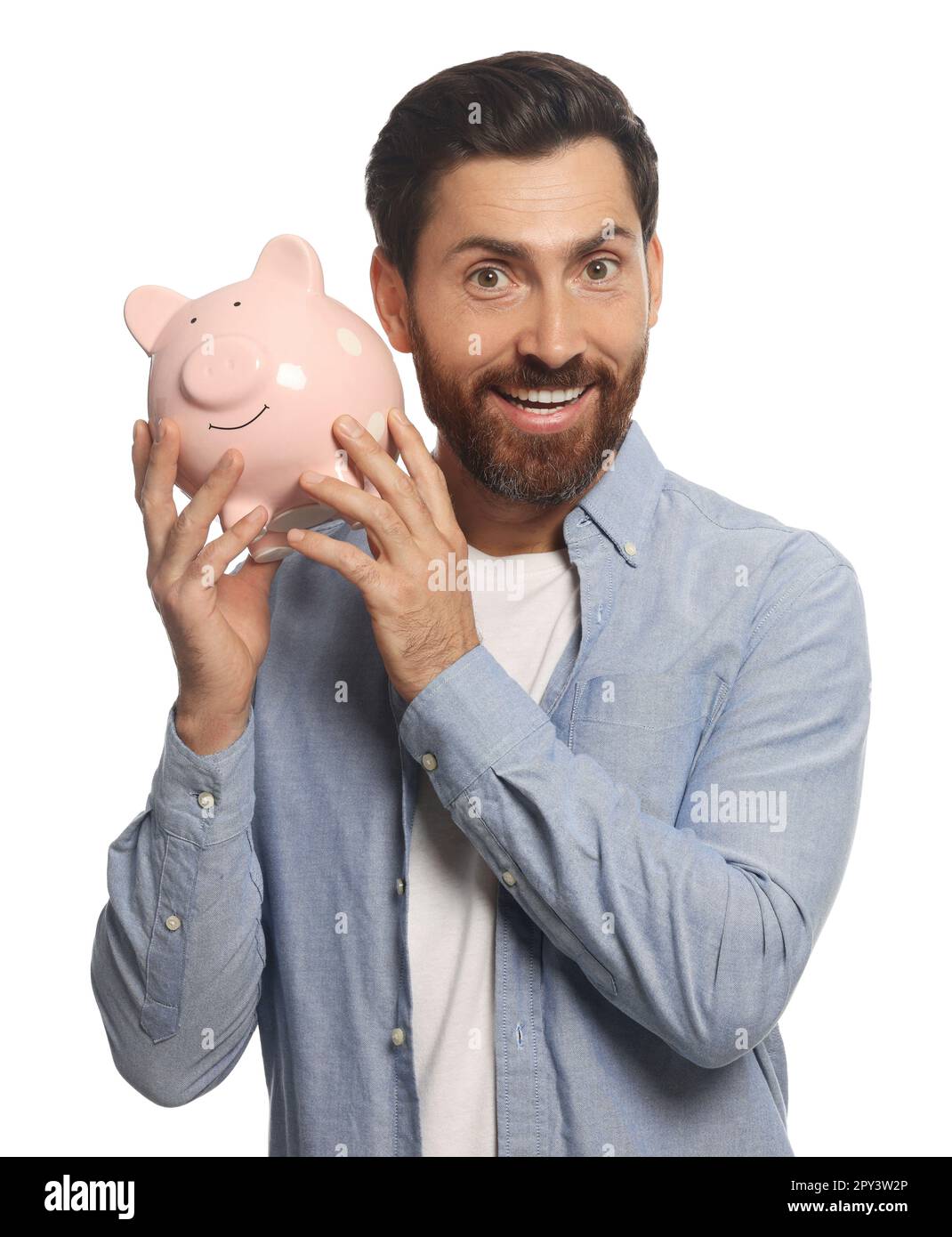 Happy man with ceramic piggy bank on white background Stock Photo - Alamy