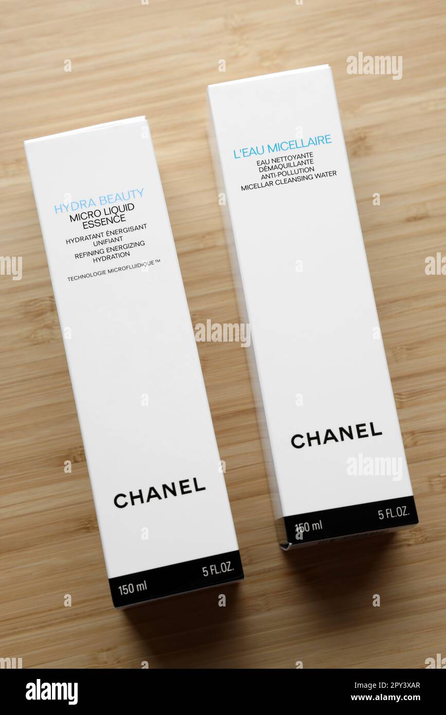 NETHERLANDS, LEIDEN - JULY 12, 2022: Chanel micellar water and micro liquid  essence in box on wooden table, top view Stock Photo - Alamy