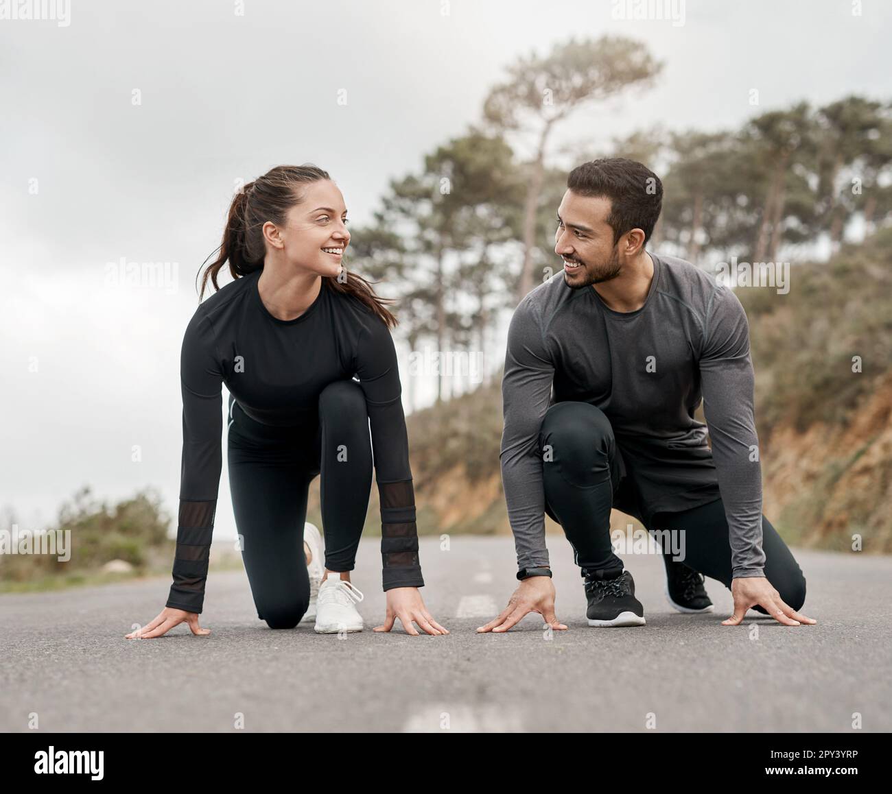 Lets race. Full length shot of two young athletes crouched down in a