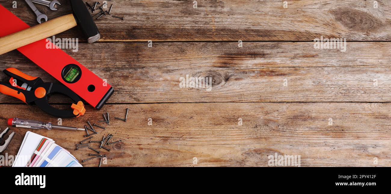 Flat lay composition with construction tools on wooden background ...