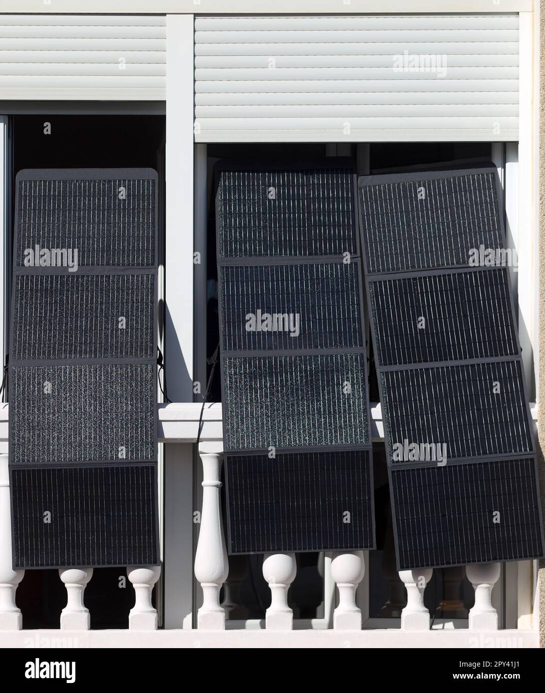 Sunlight on balcony power plant solar cells on window frontage for household photovoltaic elictricity energy Stock Photo