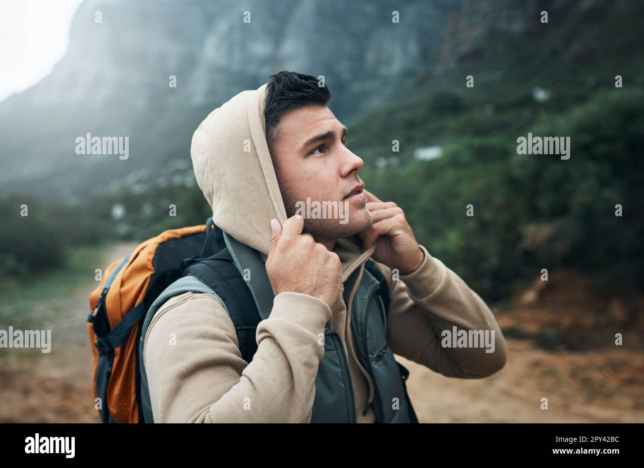 Explore the unseen. a young man hiking through the mountains Stock ...
