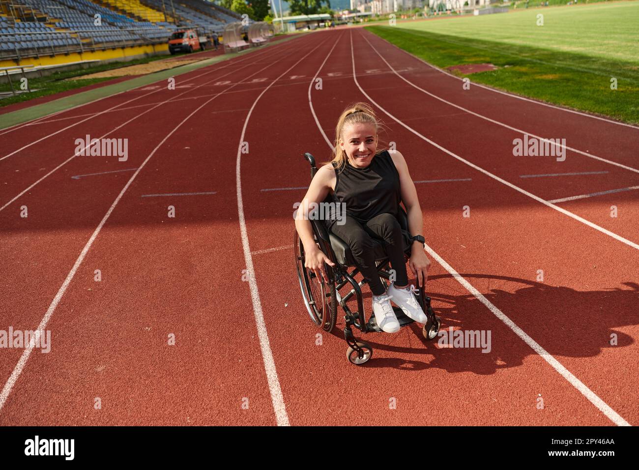 A woman with disablity driving a wheelchair on a track while preparing ...