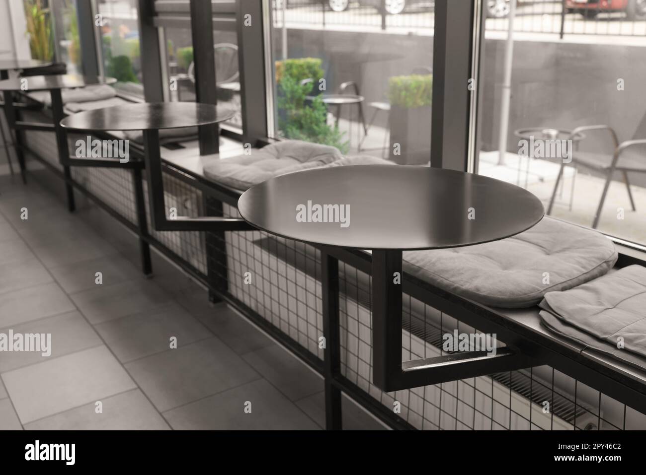 Hostel dining room interior with tables in front of window Stock Photo
