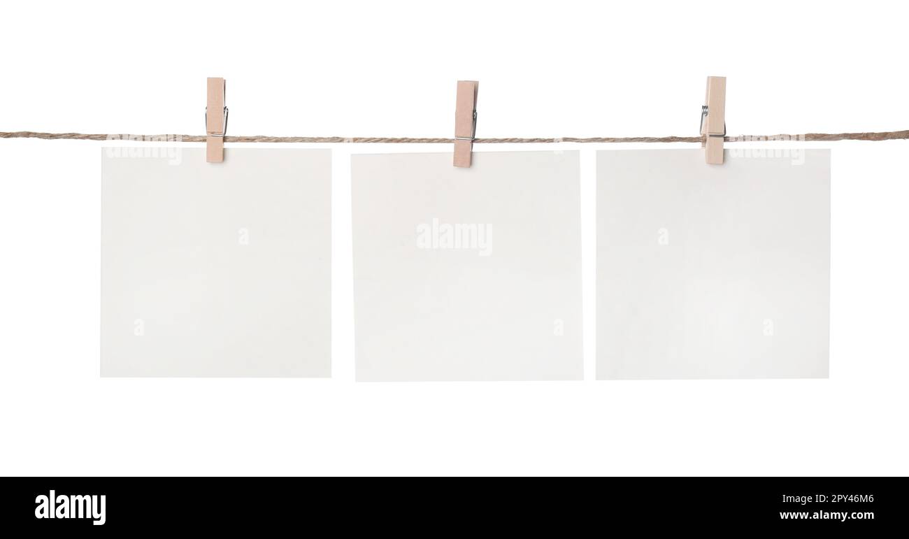 Clothespins with empty notepapers on string against white background. Space for text Stock Photo