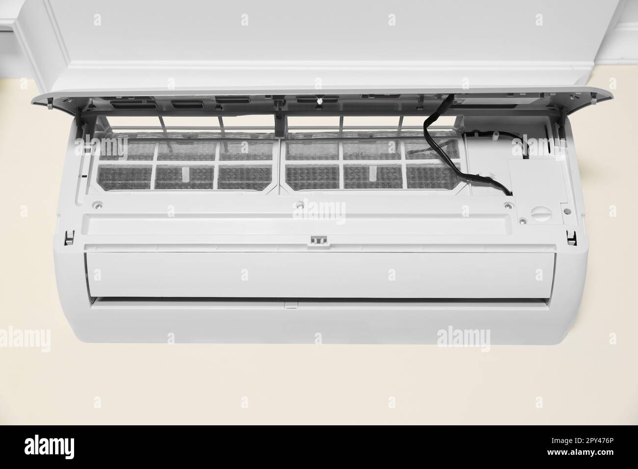 Modern air conditioner on white wall indoors Stock Photo - Alamy