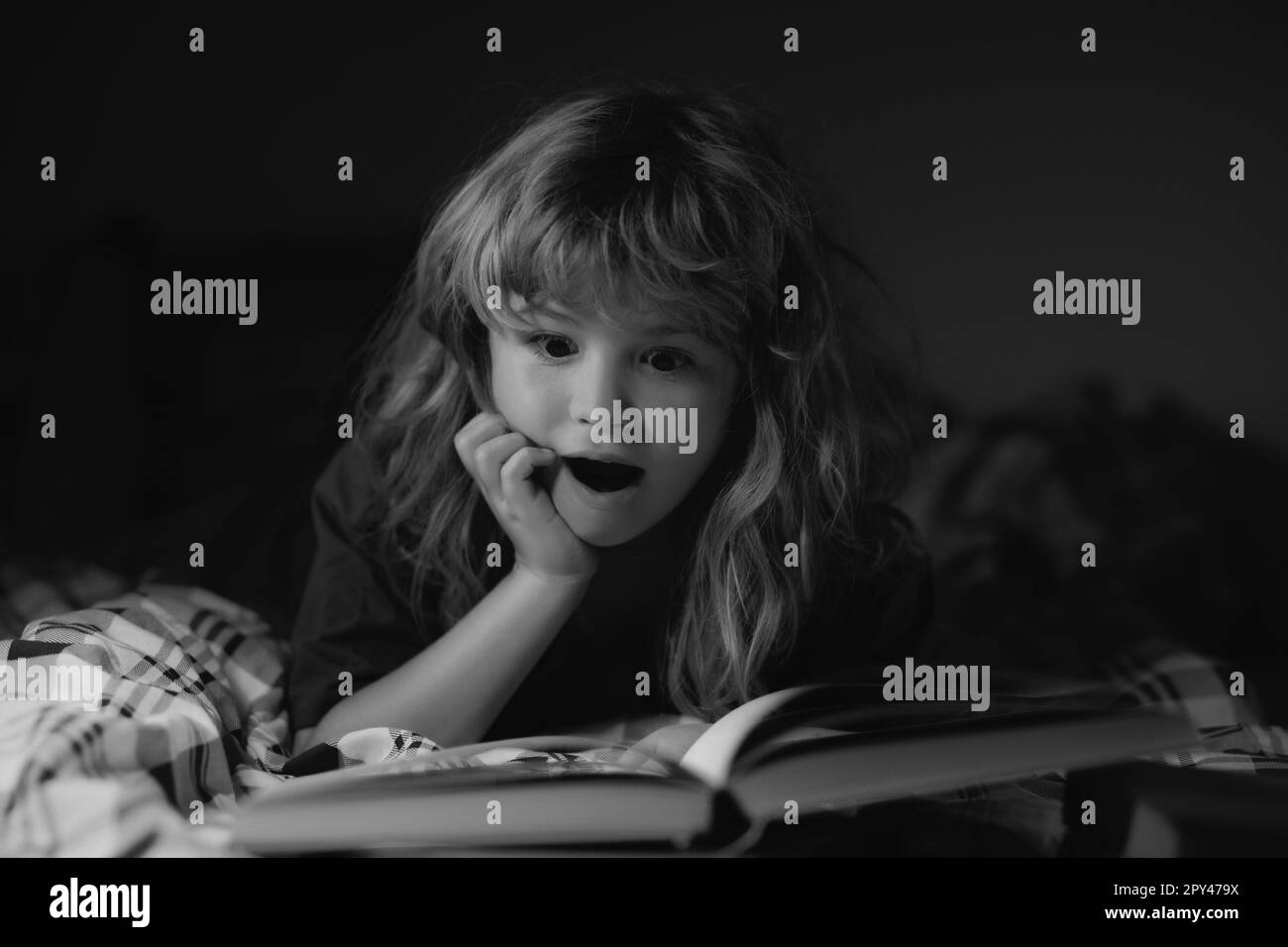 Child reading a books. Kids bedtime, boy reading a book in bed. Bedtime