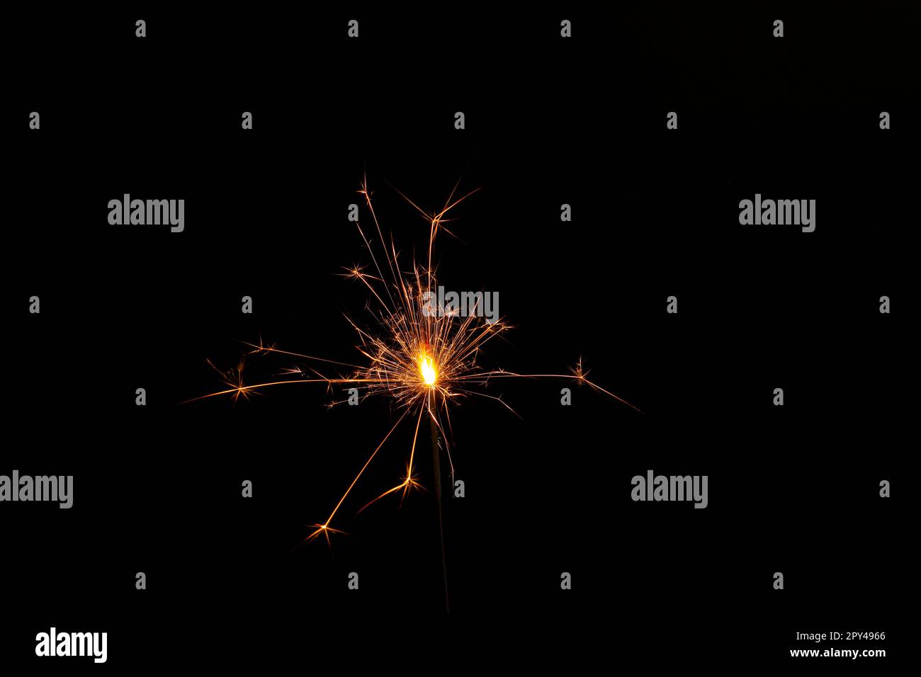 One burning sparkler stick on black background Stock Photo