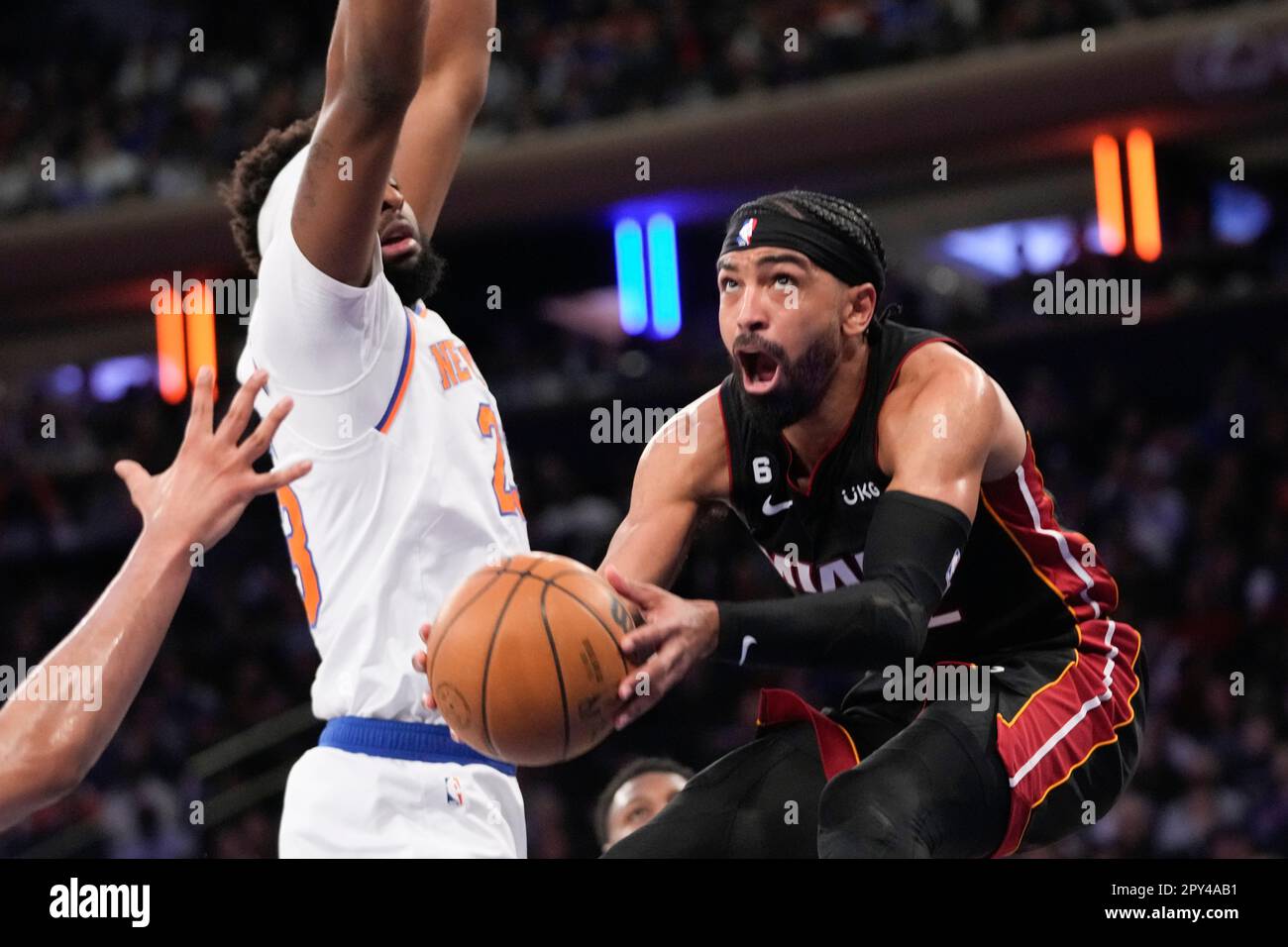 Miami Heat guard Gabe Vincent, right, goes to the basket against New York  Knicks center Mitchell Robinson (23) in the first half of Game 2 in the NBA  basketball Eastern Conference semifinals