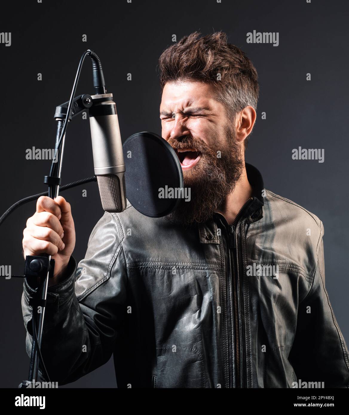 Expressive Singer Expressive singer with microphone. Singer wearing headphones is ...