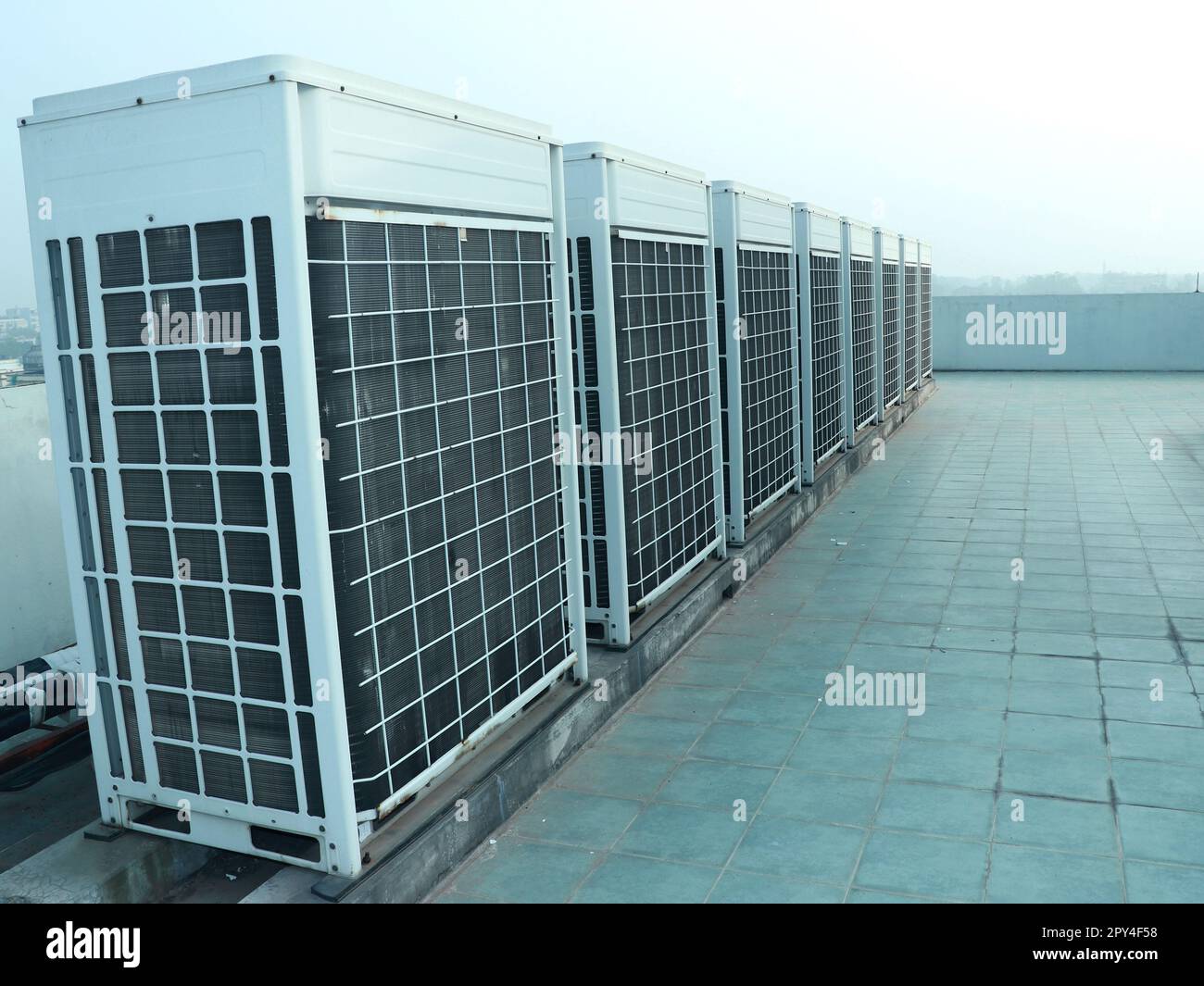 Industrial air conditioner condensers (outside unit) at the Office building rooftop. Stock Photo