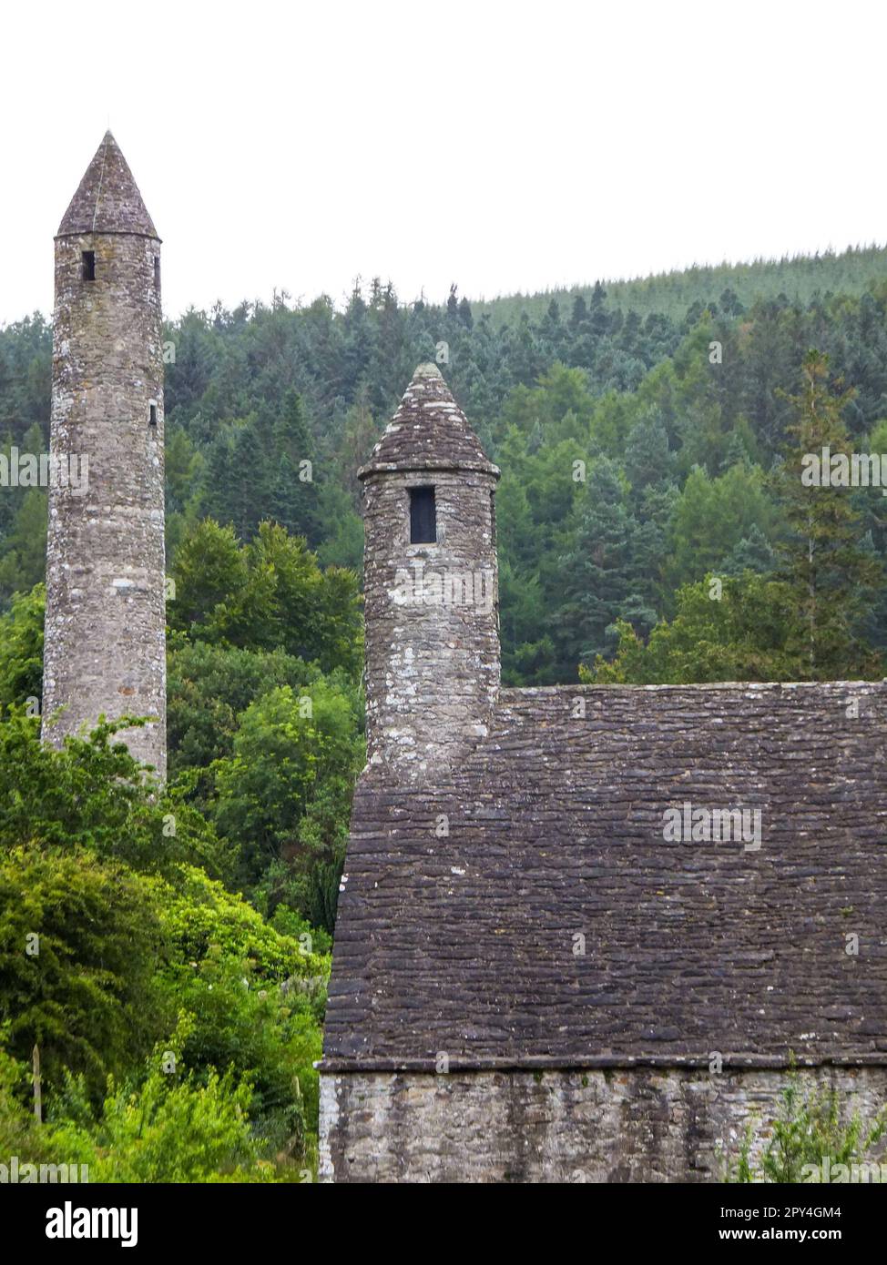 The ancient architecture of Saint Kevin's Kitchen and the Round Tower at Glendalough Monastic City in Wicklow Mountains National Park, Ireland. Stock Photo