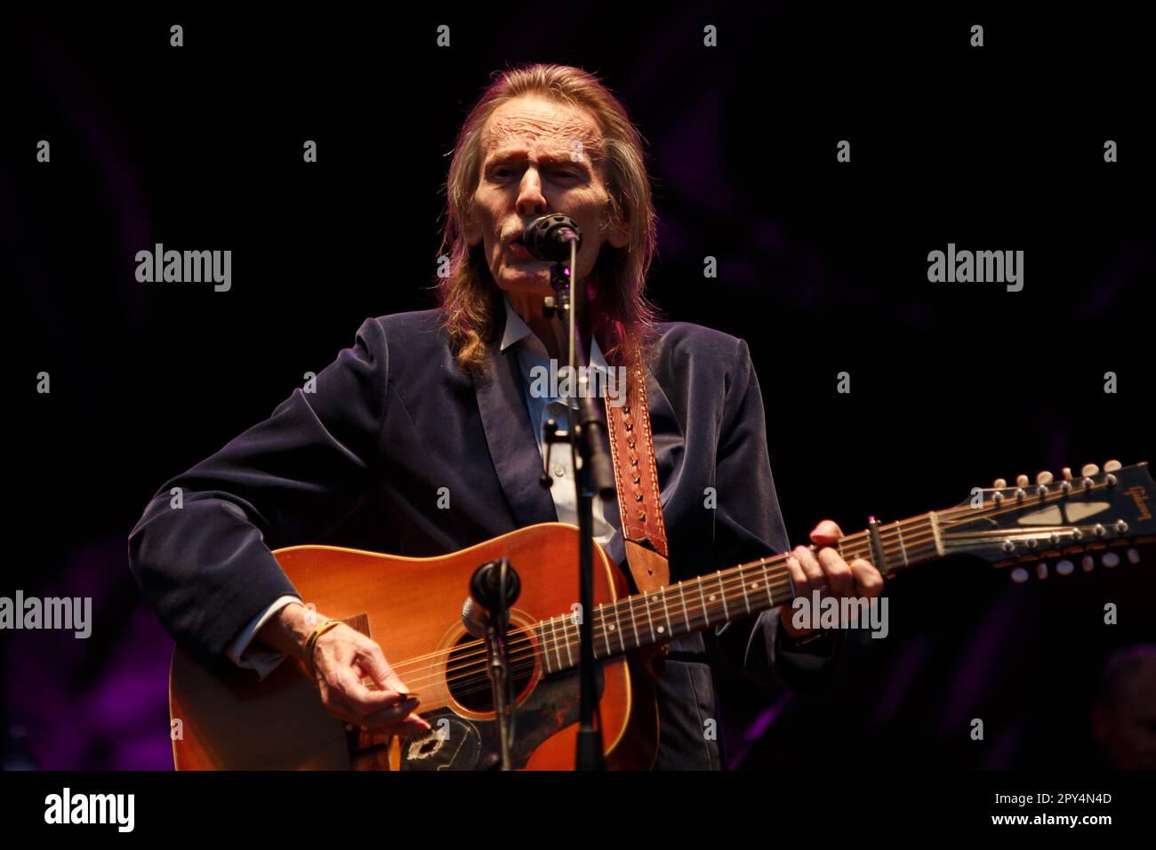Gordon Lightfoot performs on stage with an acoustic guitar on an outdoor stage at the Greenbelt Harvest Picnic in 2015 Stock Photo