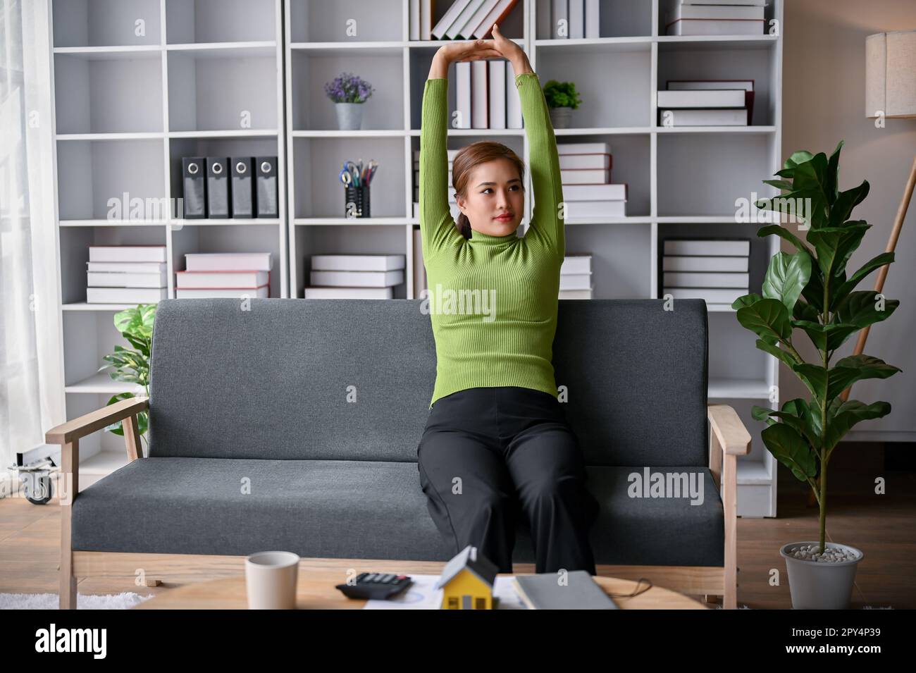 Relaxed and happy millennial Asian woman in casual comfy clothes 