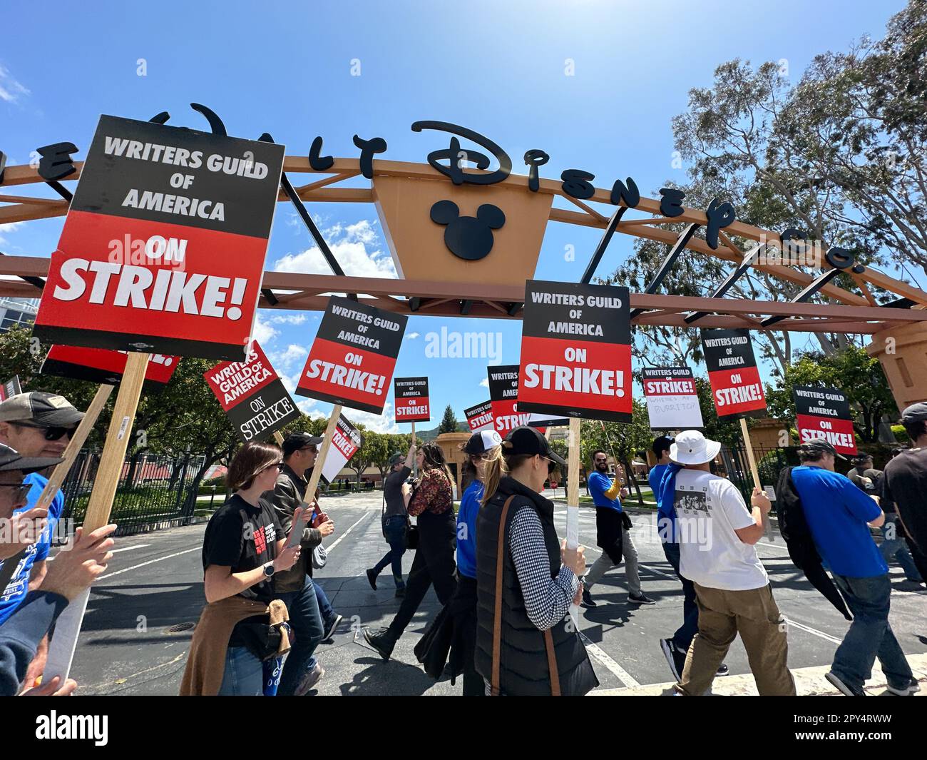 Burbank, California, USA. 2nd May, 2023. Mickey Mouse icon and picketers  under the Walt Disney sign. The Hollywood Writer's Strike began at 1:00pm  on May 2, 2023: thousands of writer's and others