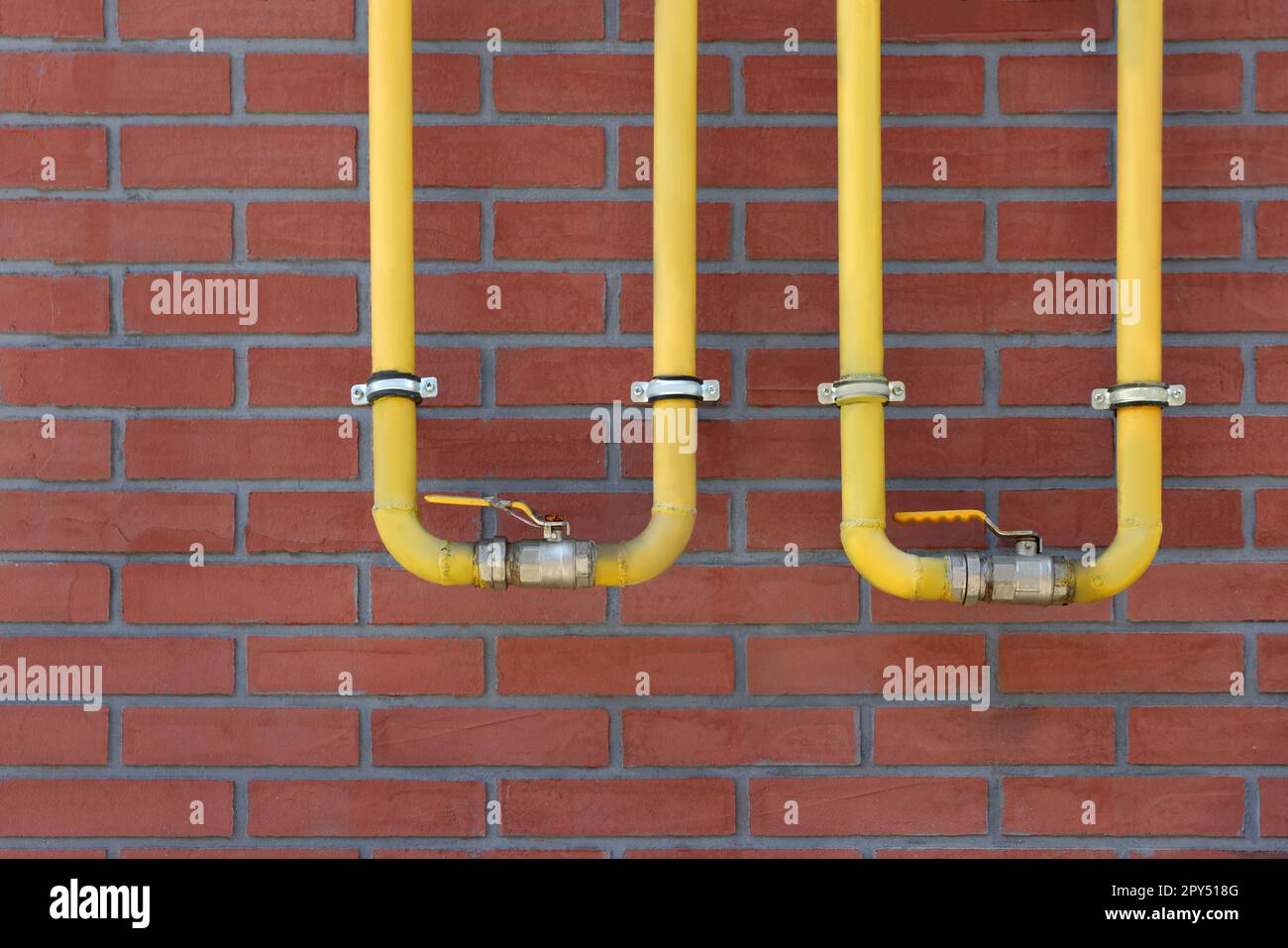 Yellow gas pipes on red brick wall outdoors Stock Photo Alamy