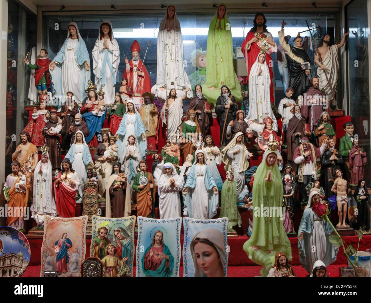 Roman Catholic paraphernalia in the form of religious statuettes, featuring Jesus, Virgin Mary, in a market stall in the modern town of Pompeii, Italy Stock Photo