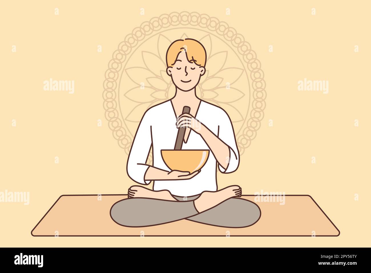 Meditating man sitting in lotus position on yoga mat using bowl to ...