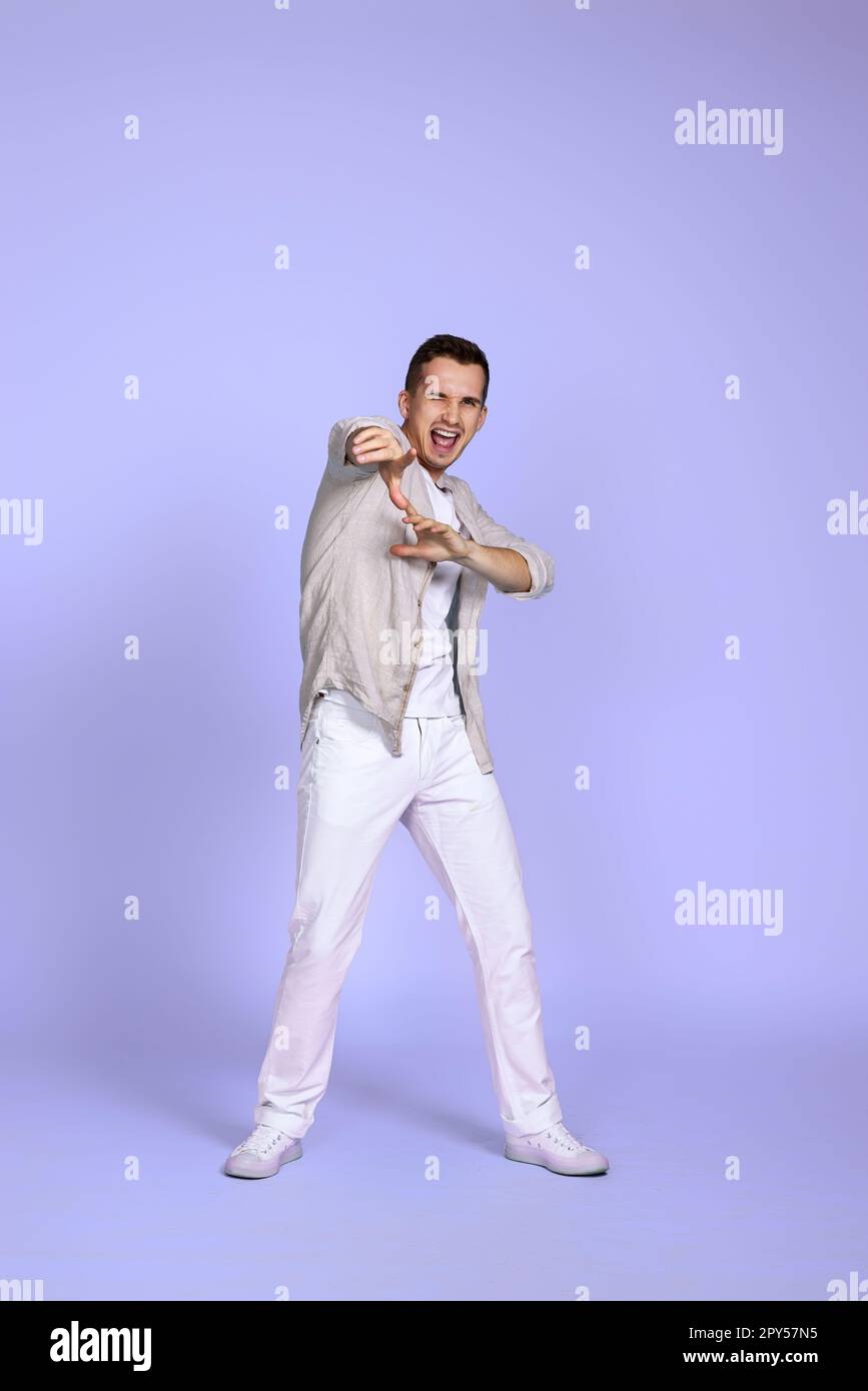 optimistic caucasian young man pointing finger on camera Stock Photo