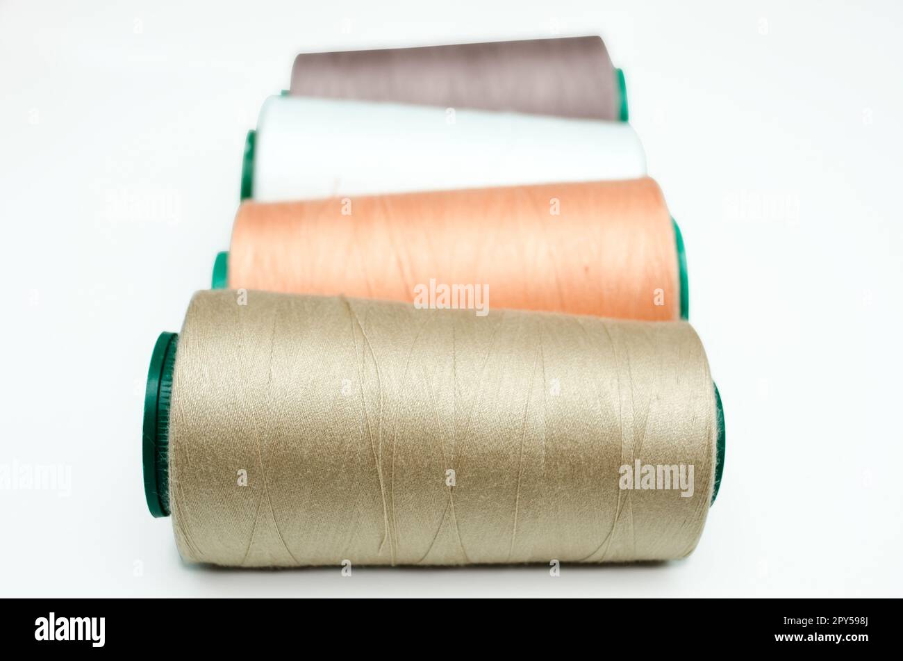 Spools of thread various color on a white background Stock Photo - Alamy